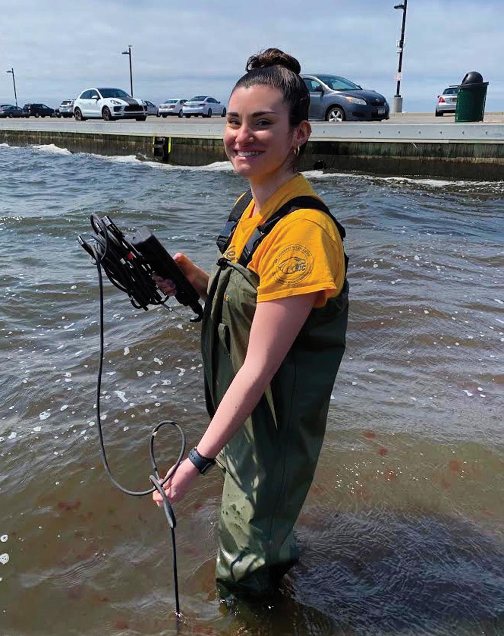 Student in water holding monitoring equipment