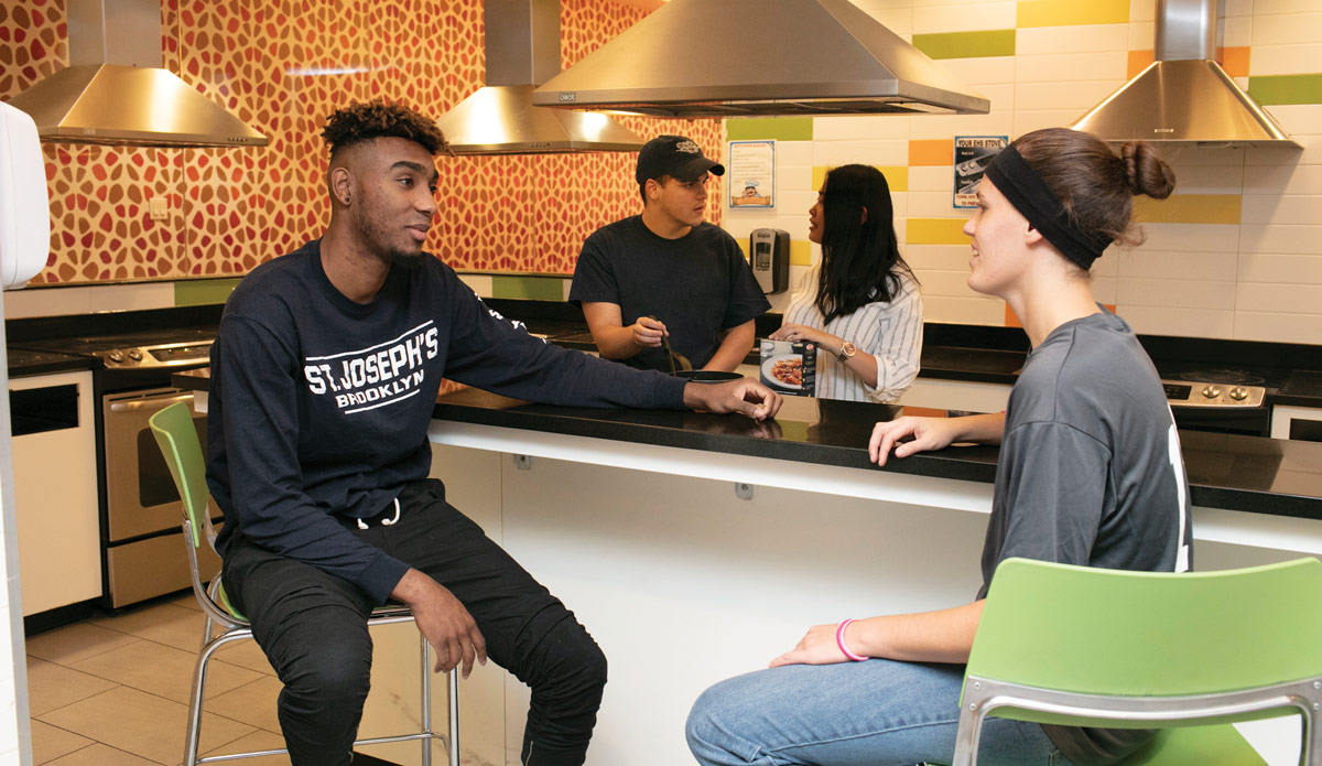 students in a kitchen talking