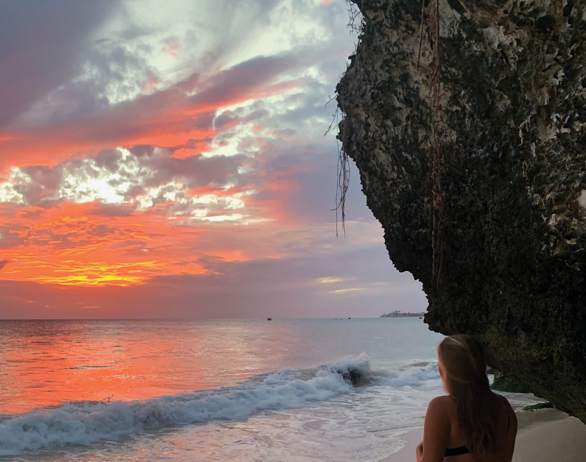 Payton Cline on the beach during sunset in Barbados