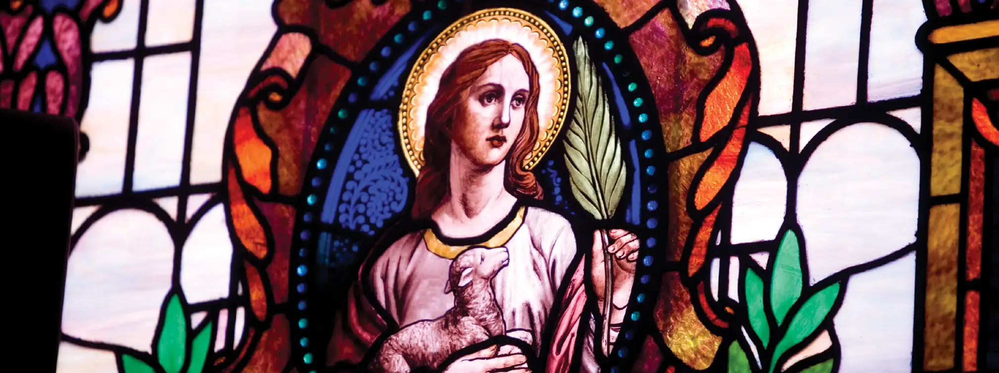 Stained glass with saint holding lamb
