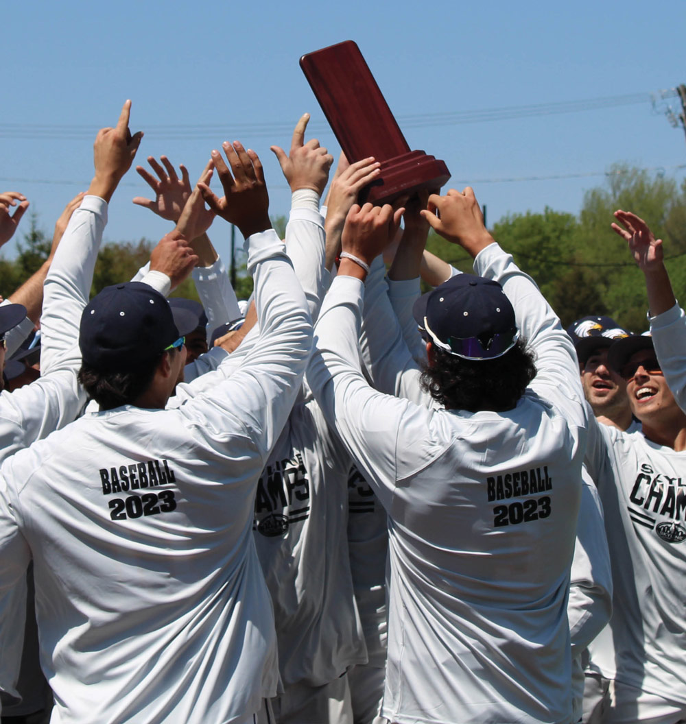 St. Joseph's Long Island Campus baseball team celebrating and holding up a trophy