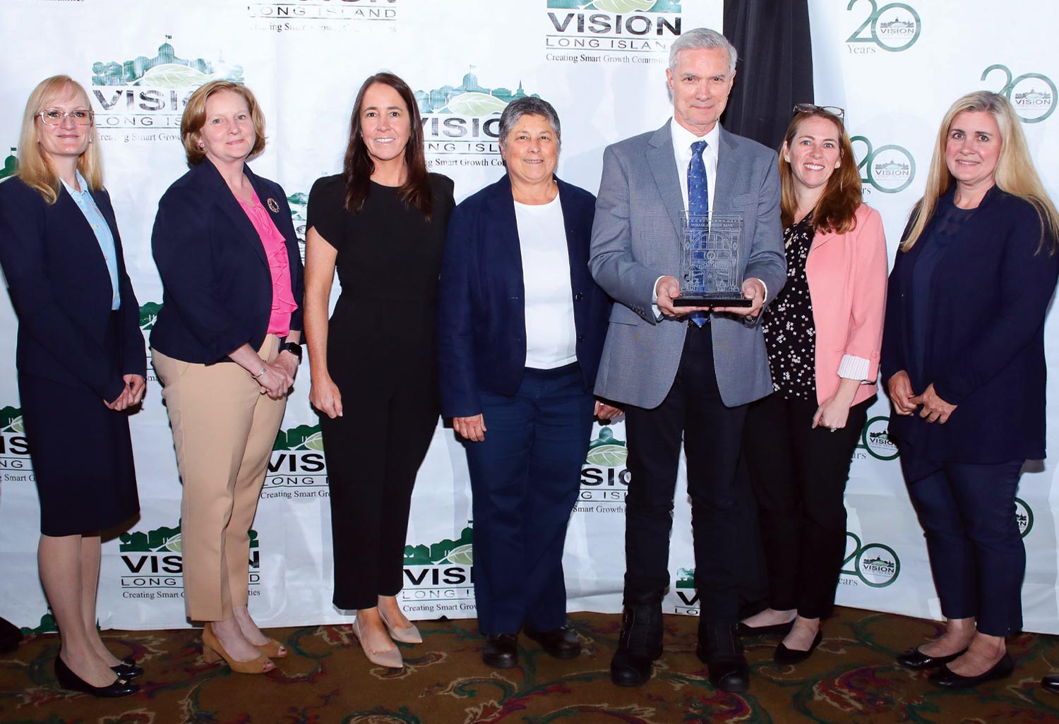 SJNY President Donald R. Boomgaarden, Ph.D. holds the the 2023 Long Island Smart Growth Award for Community Leadership while standing with St. Joseph’s administrators (from left) Heather Barry, Ph.D.; Rory Shaffer-Walsh; Christine Murphy; Gail Lamberta ’82, Ph.D.; Jessica McAleer Decatur; and Michelle Papajohn ’08, MBA ’10, M.S. ’23