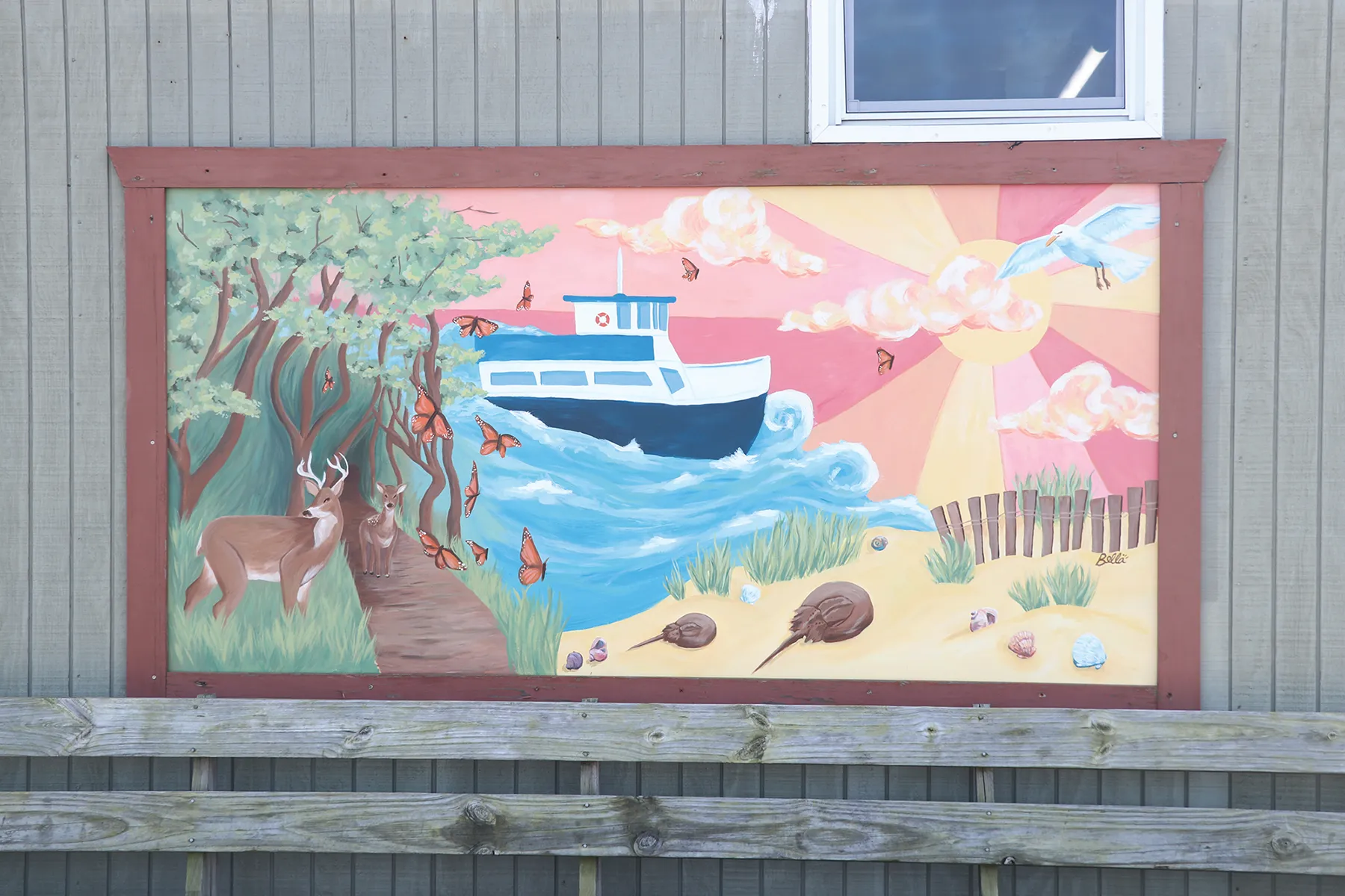 Mural depeciting ferry, beach shore and wooded path
