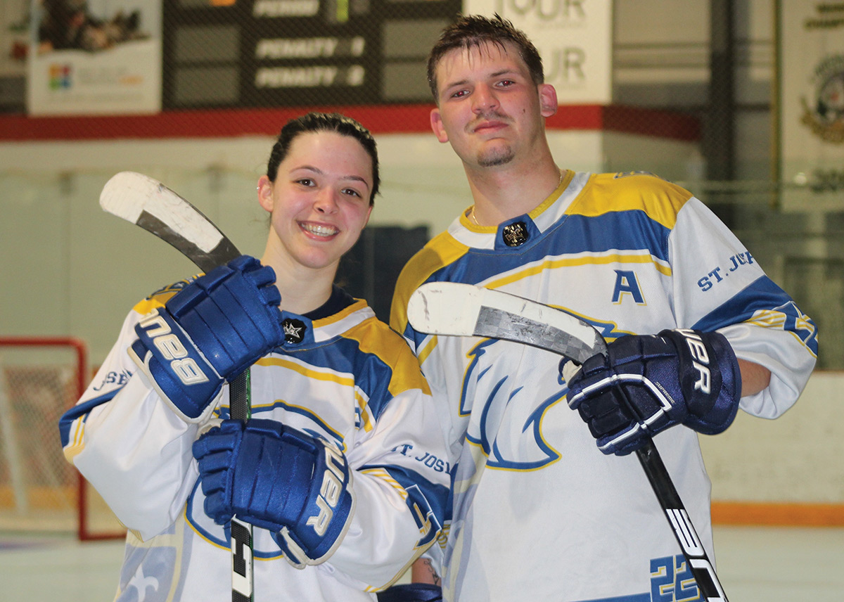 Dominick Strebel and female teammate in hockey uniforms posing for a picture