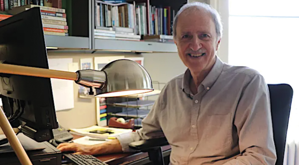 Raymond D’Angelo sitting at his desk in his office