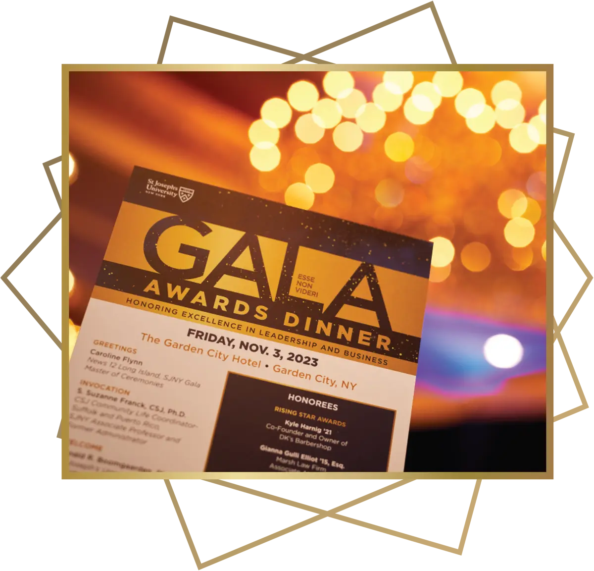 close view of the St. Joseph's University Gala Awards Dinner program, an elegant chandelier glows out of focus in the background