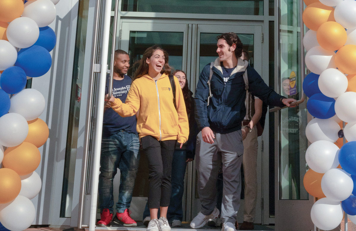 students smiling while walking out doors