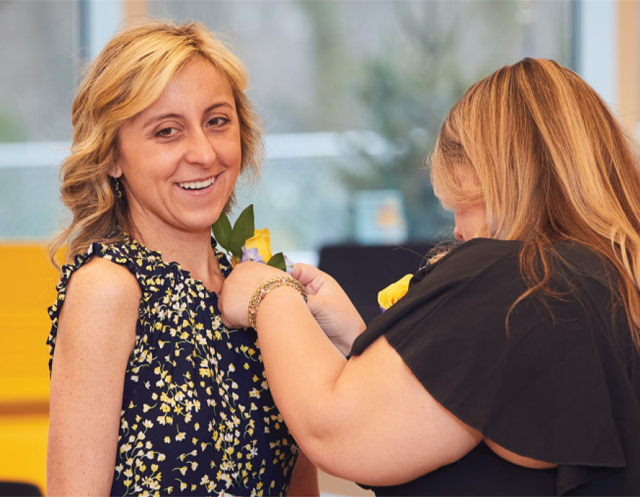 Alexandra Ehrhart getting a pin put onto her shirt