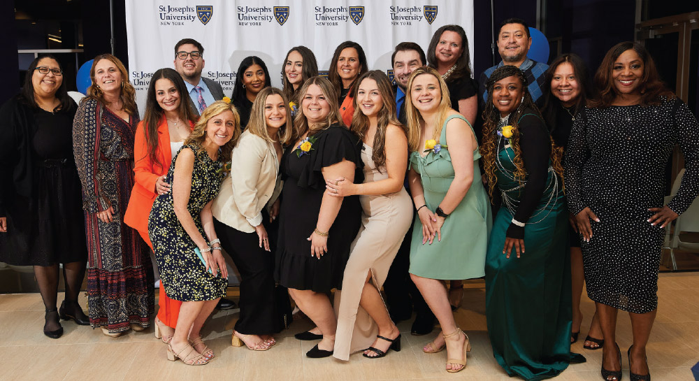 first MSW graduating class taking a group photo at a special pinning ceremony