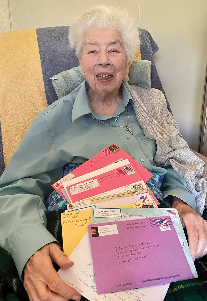 Sister Mary Florence sitting in an armchair with many different colored enveloped letters in her lap