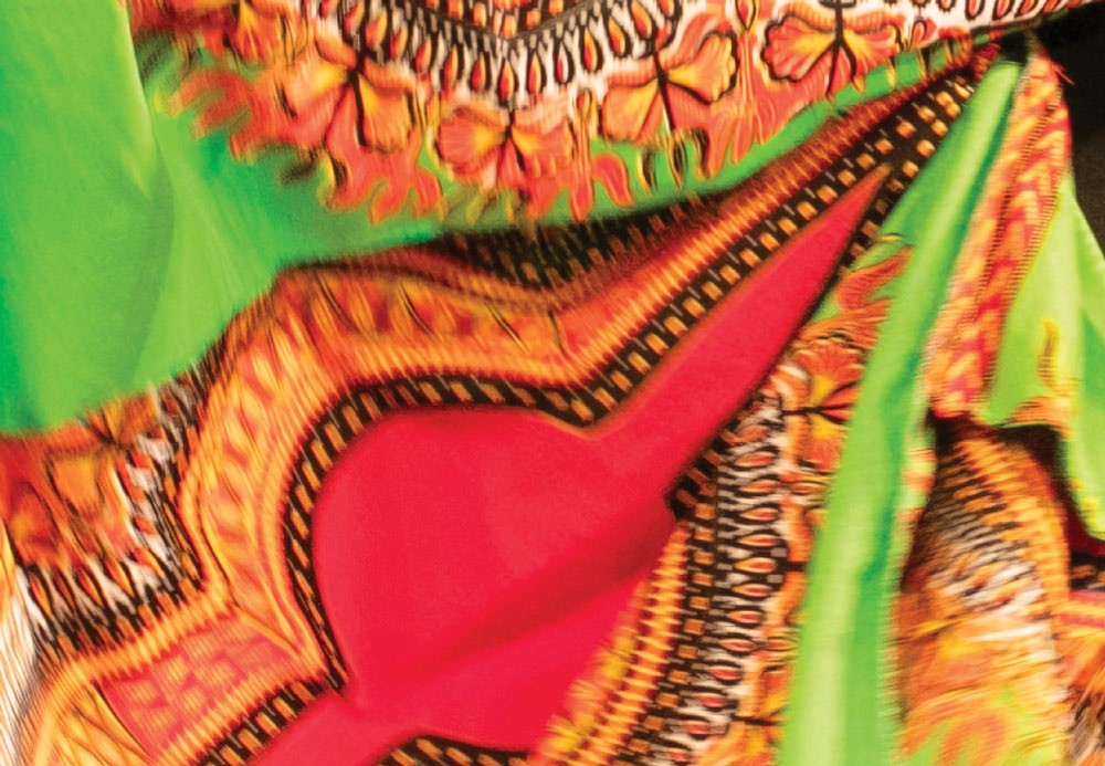 Colorful patterned fabric with orange, red, and green design.
