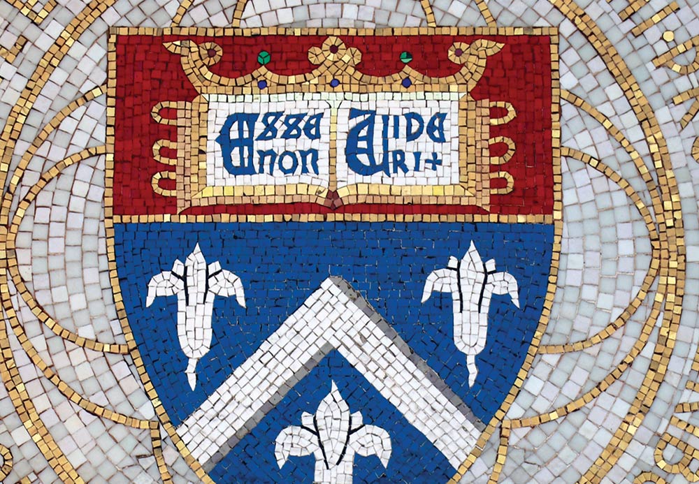 A mosaic crest featuring an open book, a crown, and fleurs-de-lis.