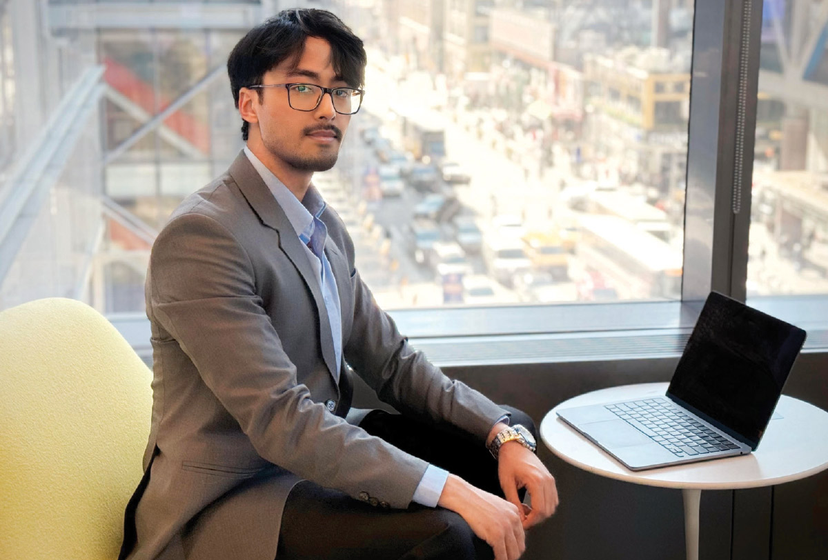 Sulabh Katila sitting on a sofa in front of an open laptop