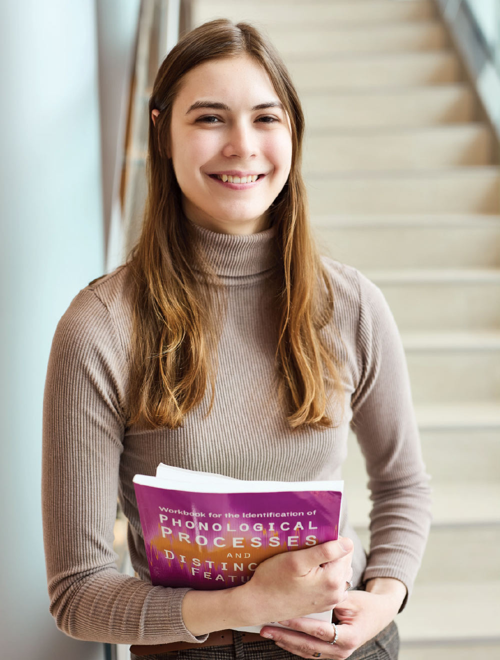 Isabel Themann smiling and holding books 