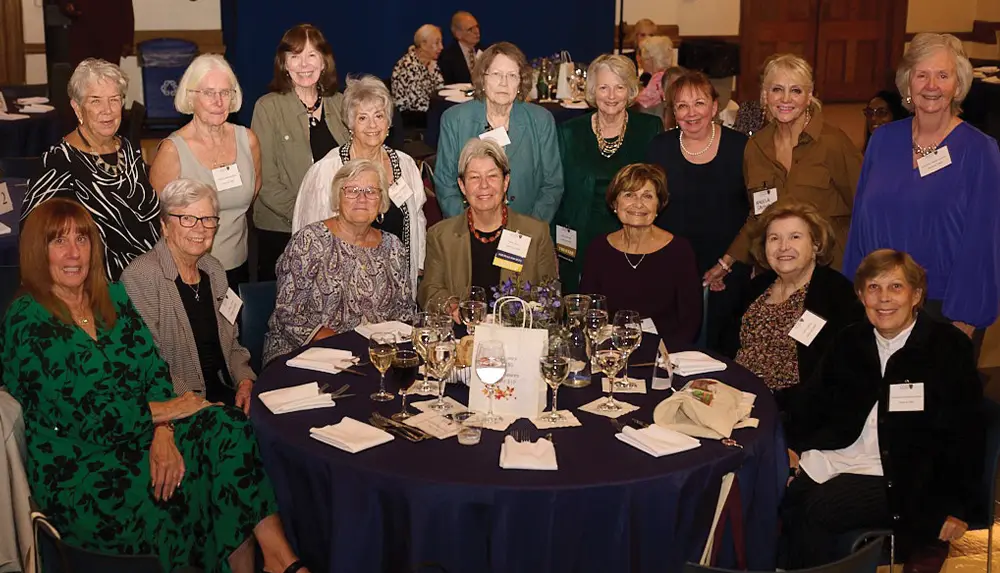SJNY Class of 1969 posing together at a round table