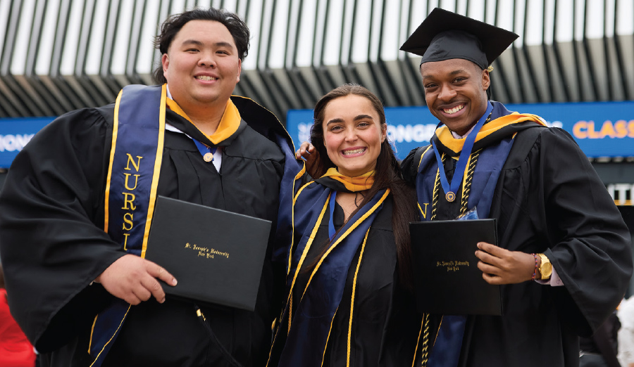 three students in caps and gowns