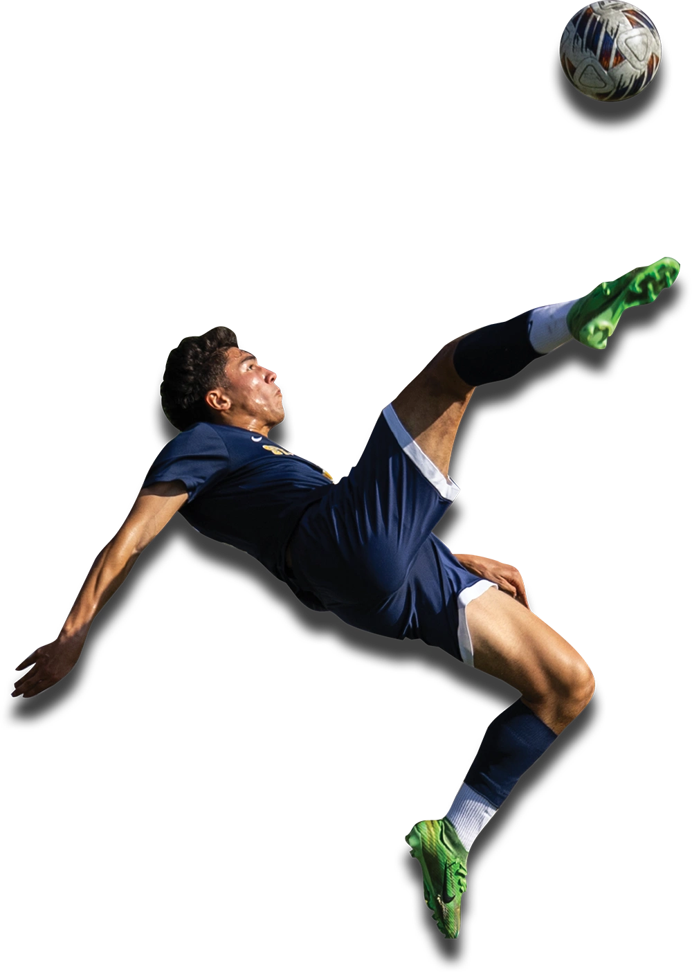 Action shot of a male St. Joseph’s University soccer player in a blue uniform performing a high mid-air bicycle kick against a white background, eyes focused on the ball above him.