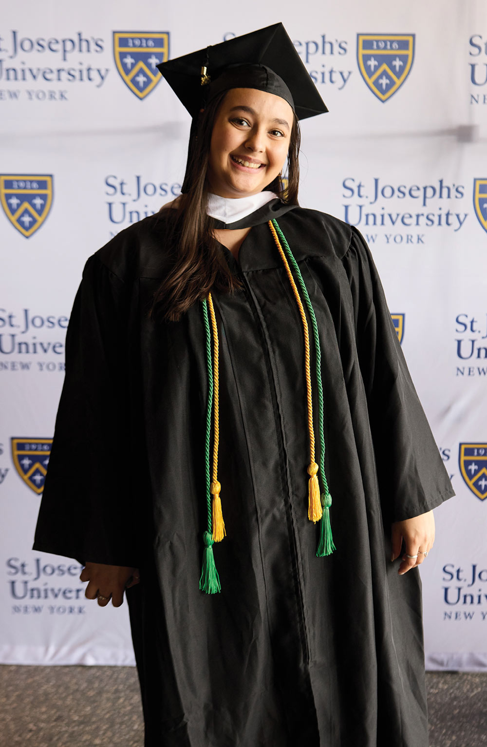 SJNY student in cap and gown at graduation