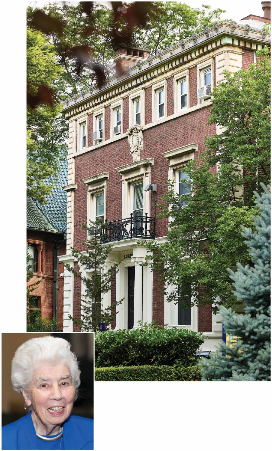 A multi-story brick building with white trim and a balcony, with a small inset portrait of an elderly woman in a blue suit.